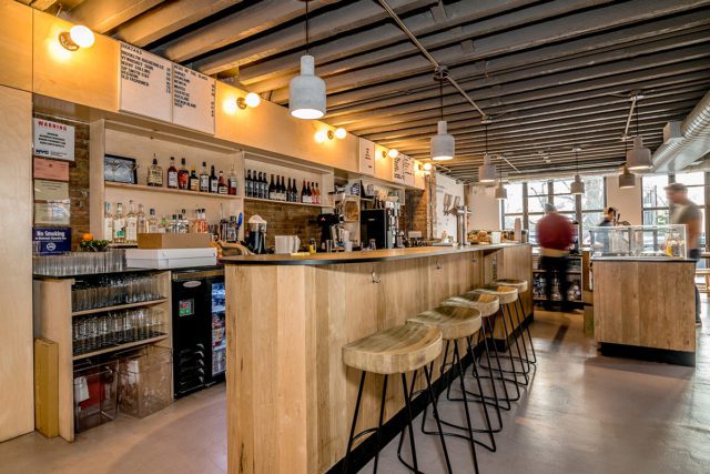East One Coffee Roasters' cafe design by Blueberry Builders features sleek interiors for the Scandinavian cafe/restaurant.