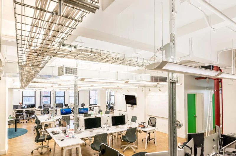 Hybrid office floor plan built for Gust mixing open collaboration and private focus zones. Source: Blueberry Builders