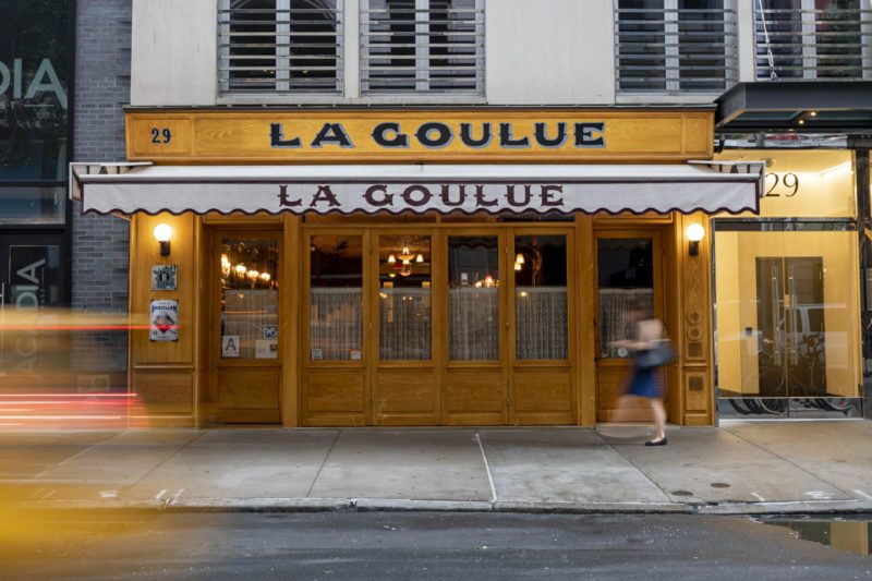 Exterior of La Goulue restaurant with an elegant storefront, large windows, outdoor seating, and a prominent entrance Source: Blueberry Builders
